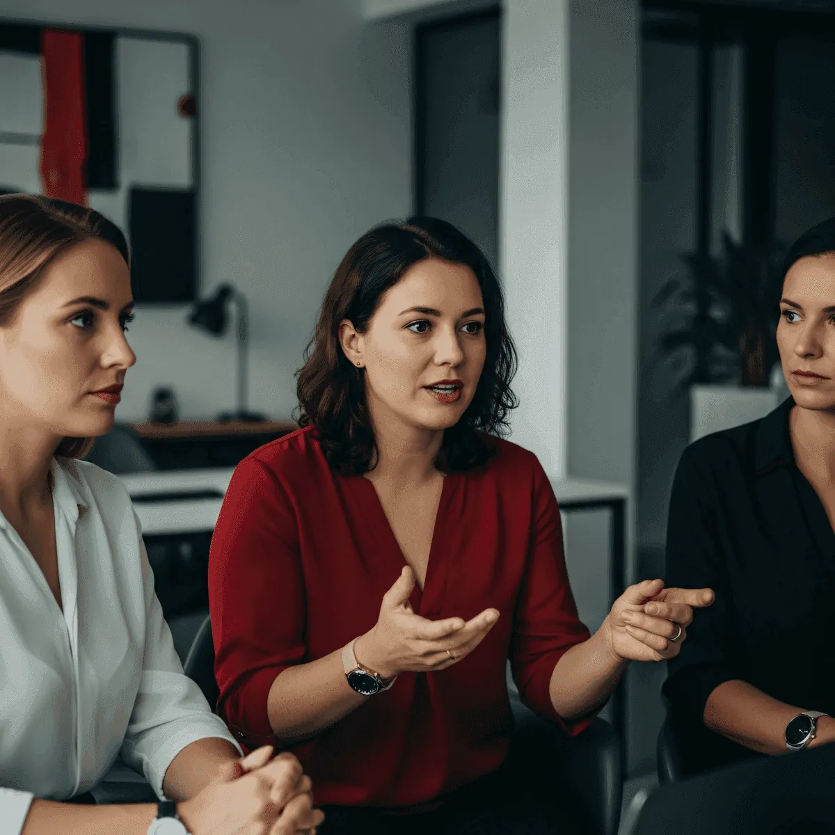 A consultant talking with two clients across a table