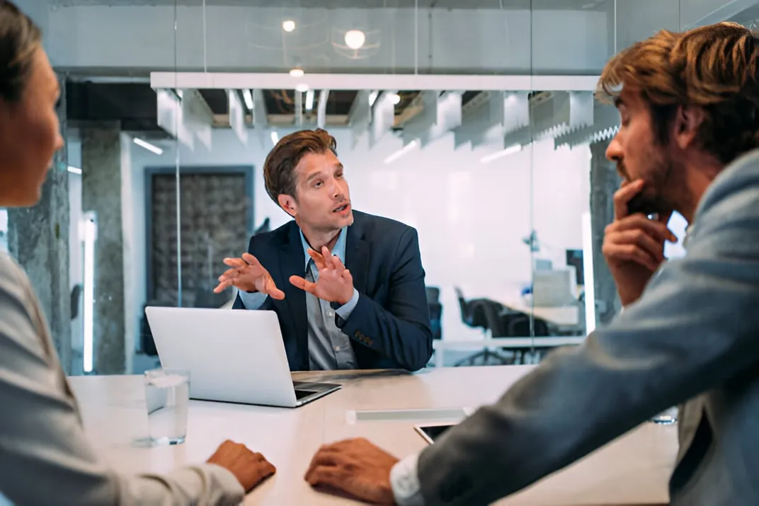 A consultant presenting to colleagues at a meeting