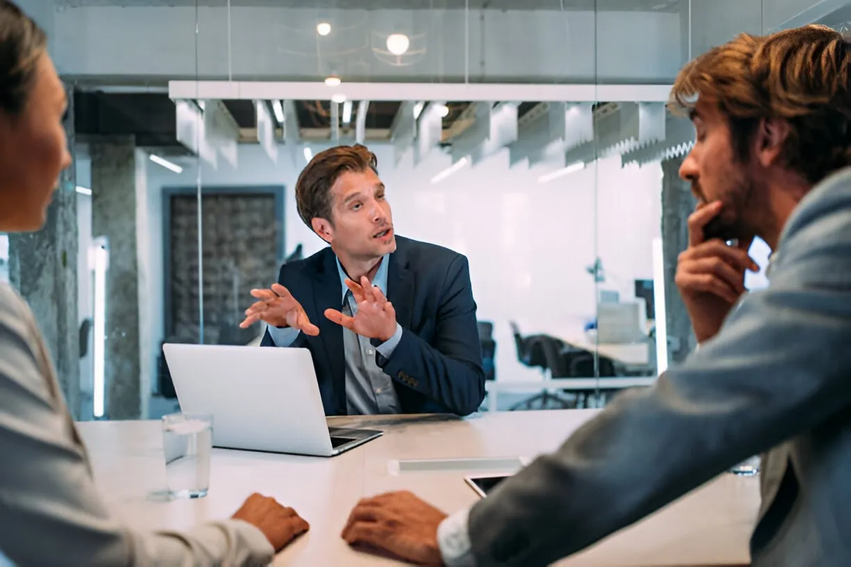 A consultant presenting to colleagues at a meeting