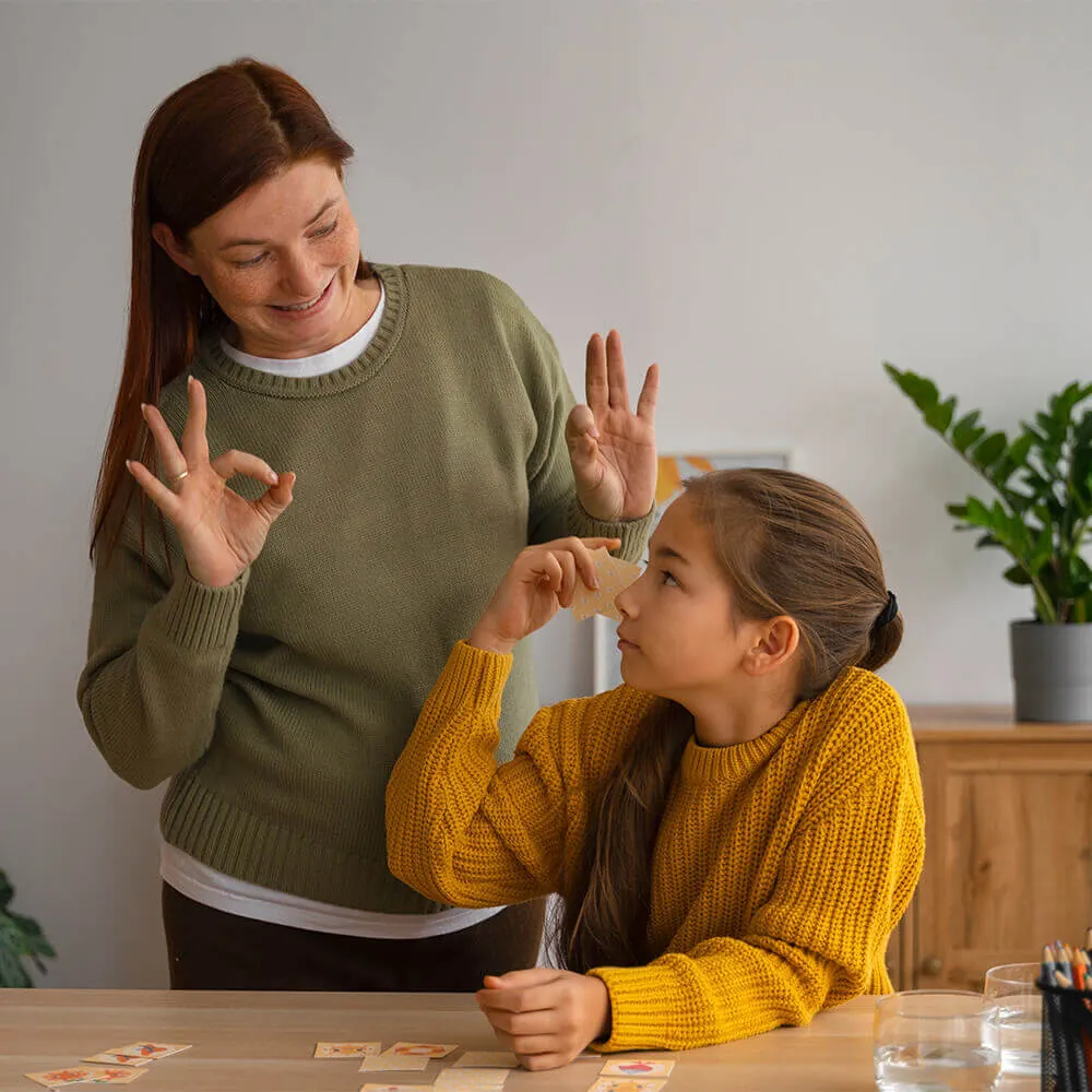 A mother and her daughter signing to each other