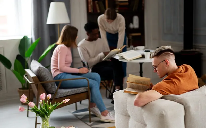 Friends reading together in a living room