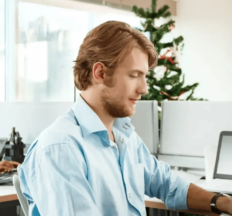 A founder working on a laptop in a bright office