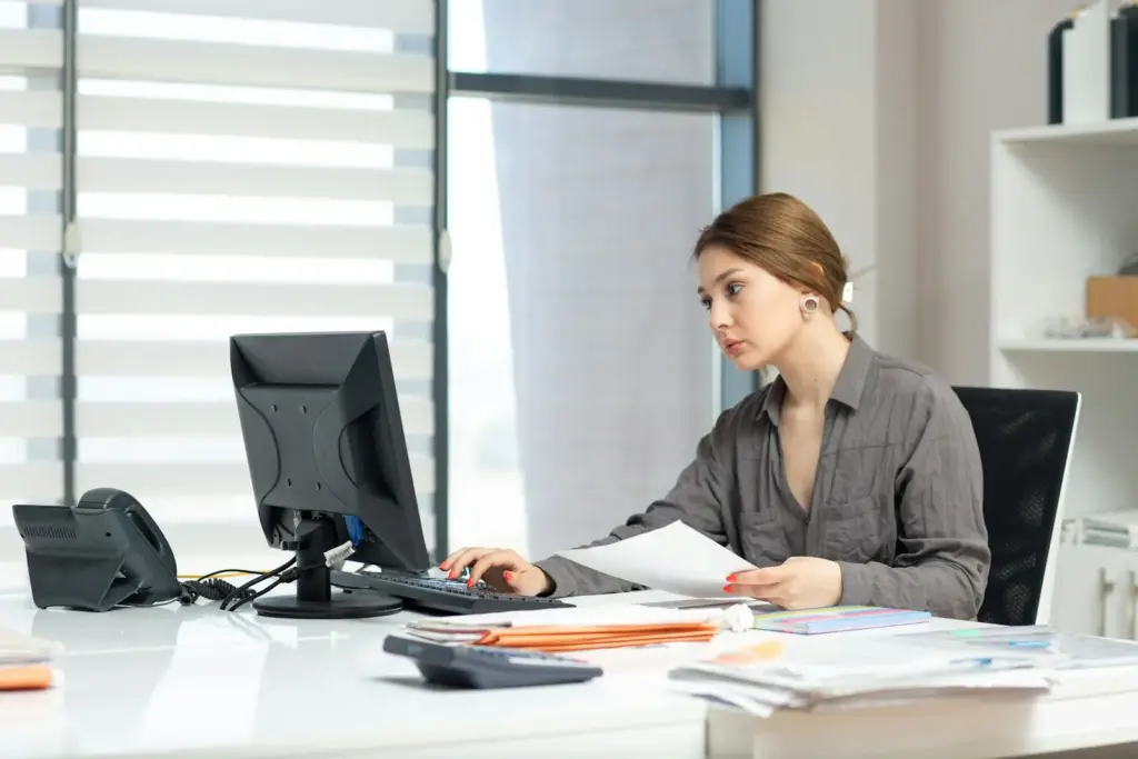 Accountant working through papers at an office desk