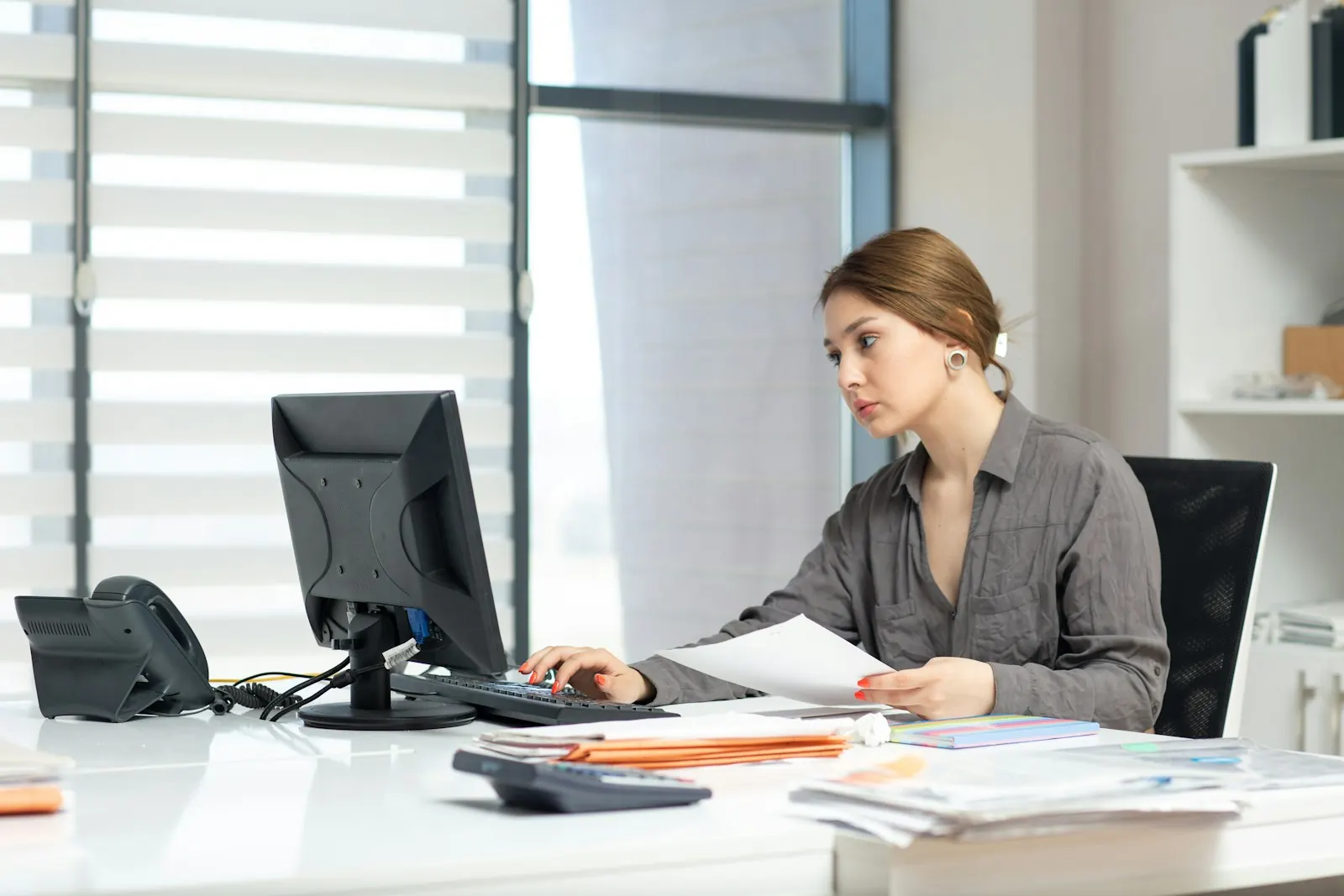 Accountant working through papers at an office desk