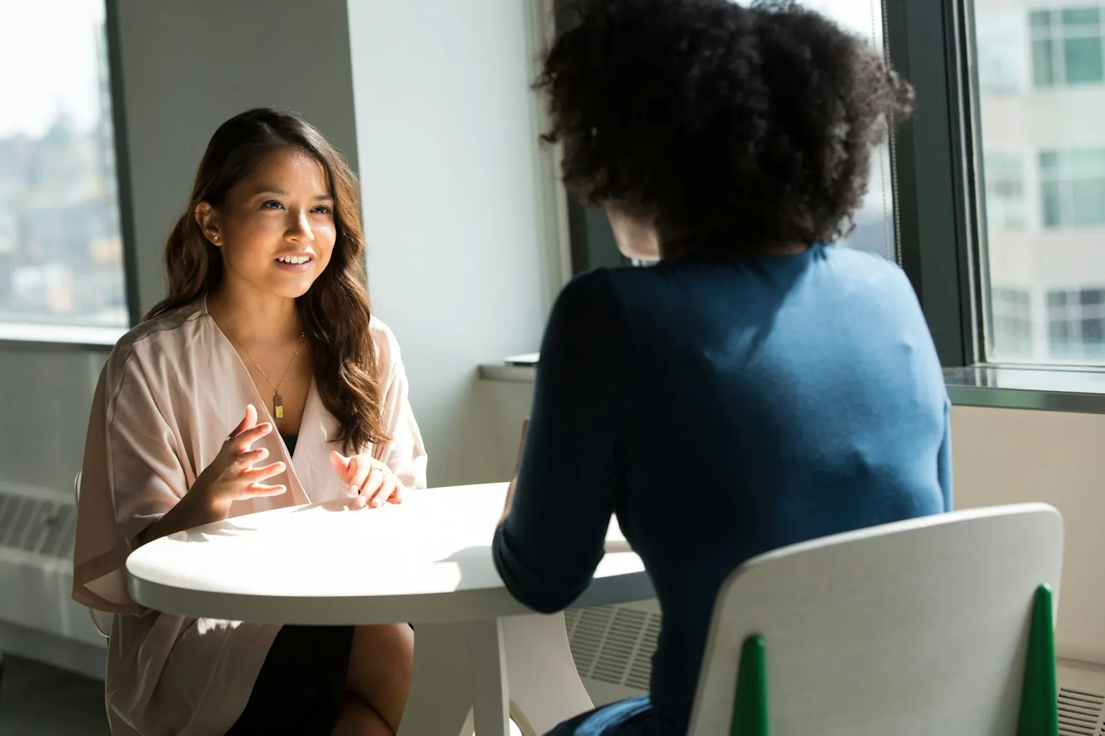 Two colleagues in conversation at a table