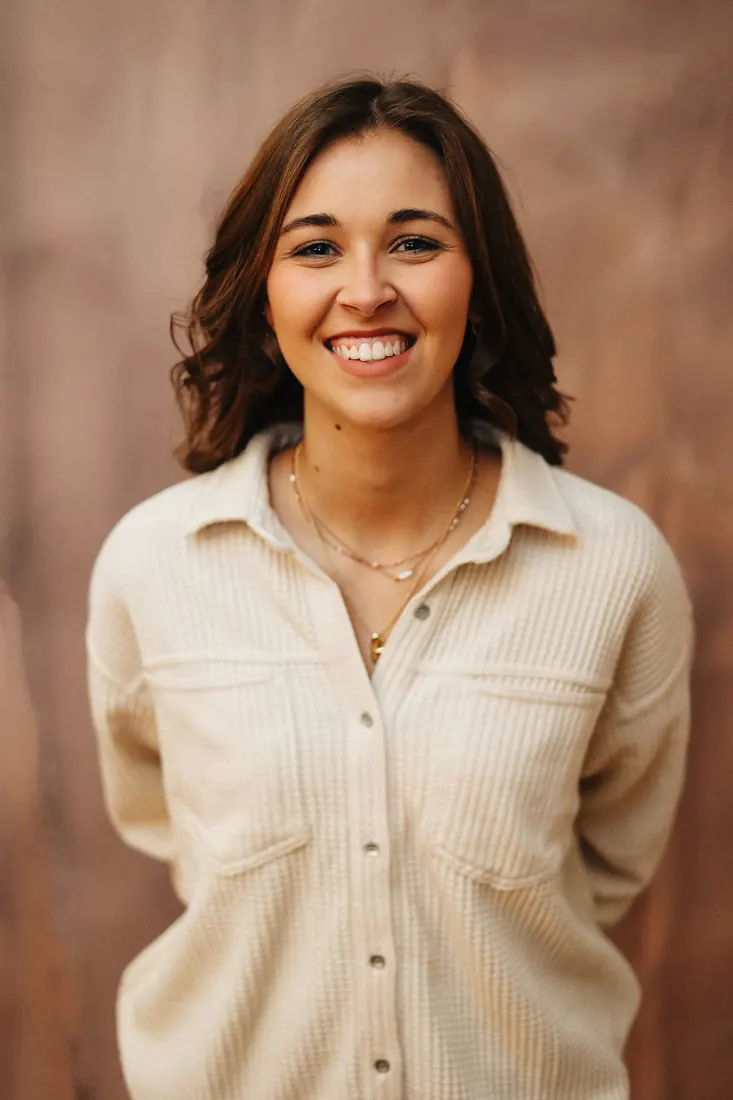 Smiling woman in a cream shirt