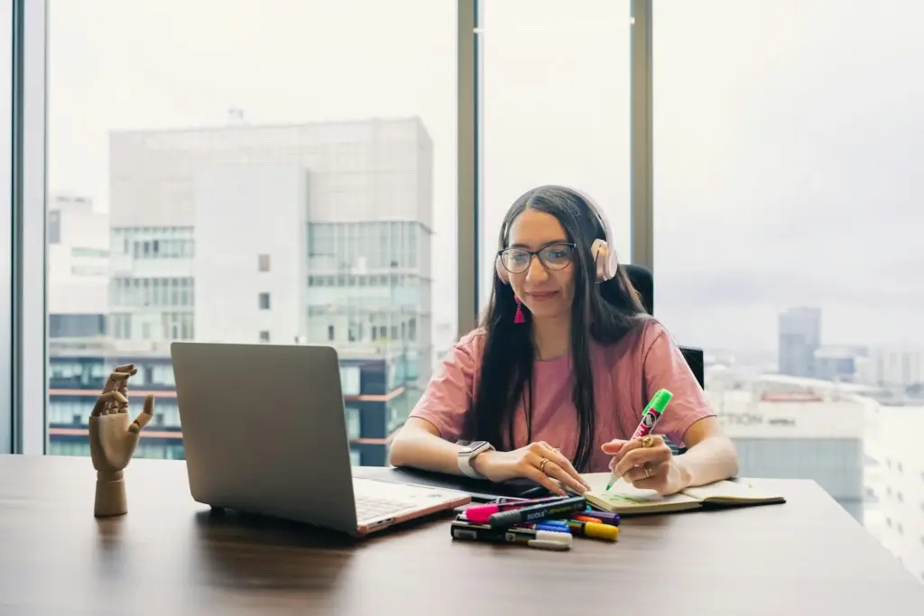 Woman planning at a desk with a city view