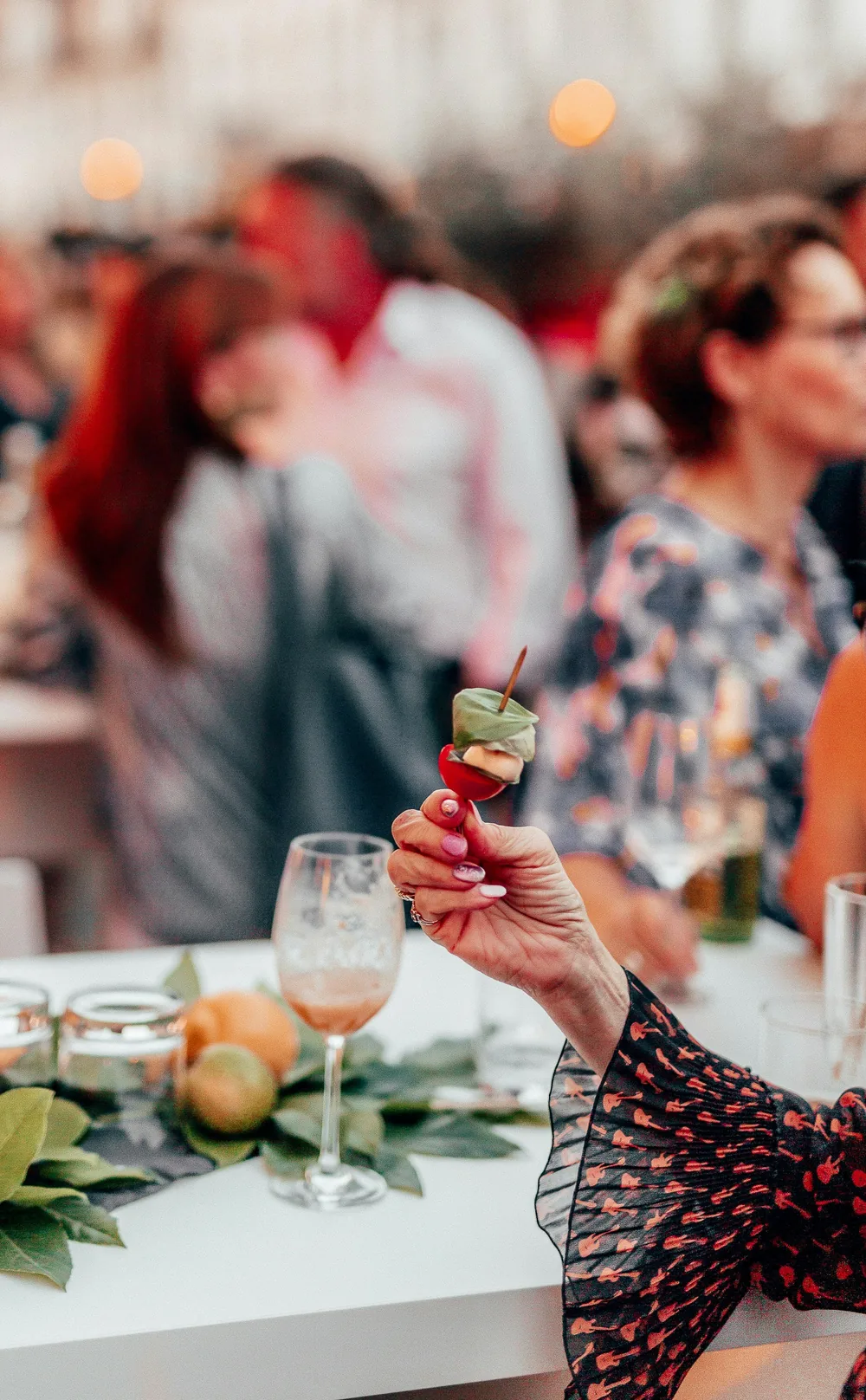 A guest raising a glass at a catered celebration
