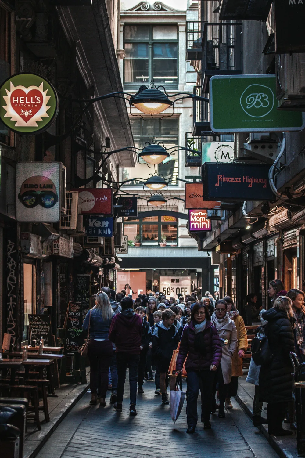 A busy city laneway lined with cafés and shops