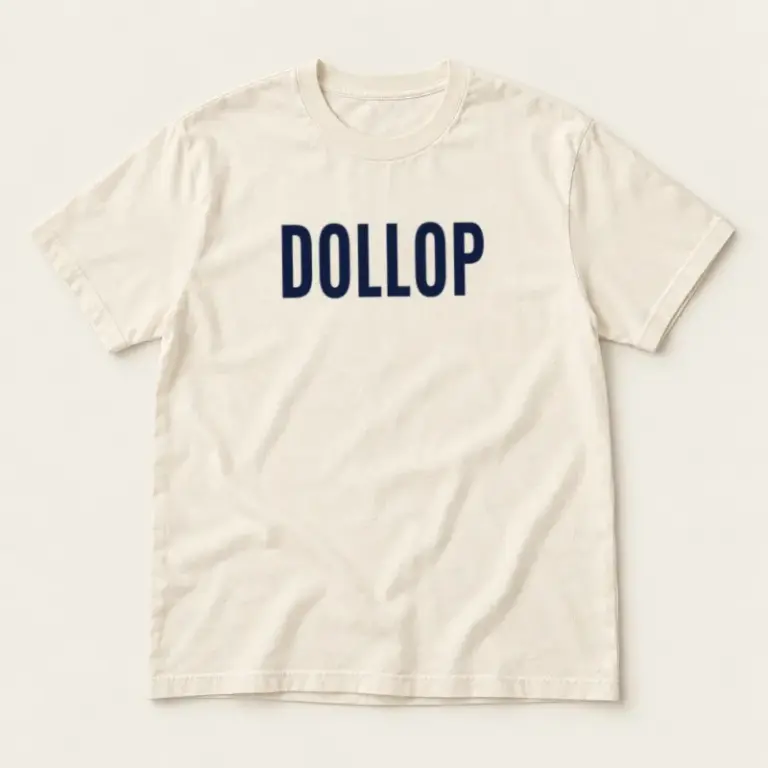 Ivory cotton T-shirt with a navy Dollop chest logo on a warm off-white background.