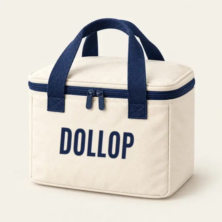 Cream insulated pint bag with navy handles and a Dollop logo on a warm off-white background.