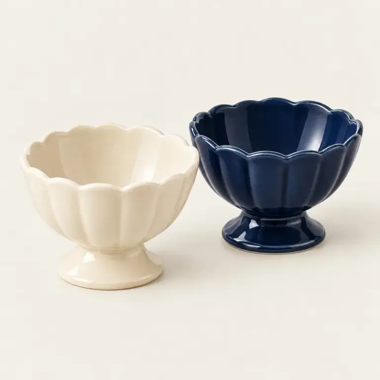 Cream and navy ceramic sundae bowls on a warm off-white background.