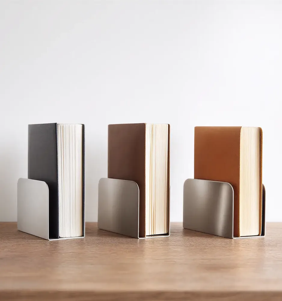 Three books standing between metal bookends