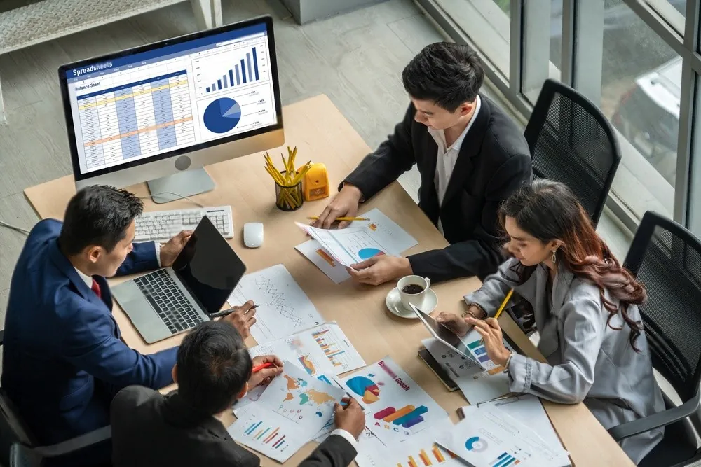 Two people going over figures at a desk
