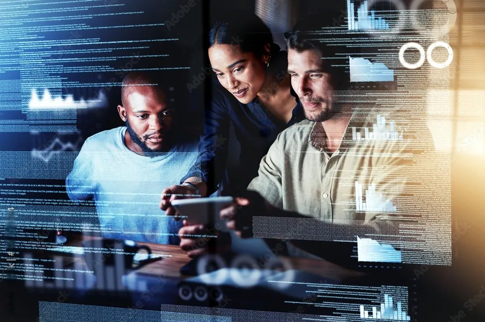 Colleagues reviewing charts on a screen