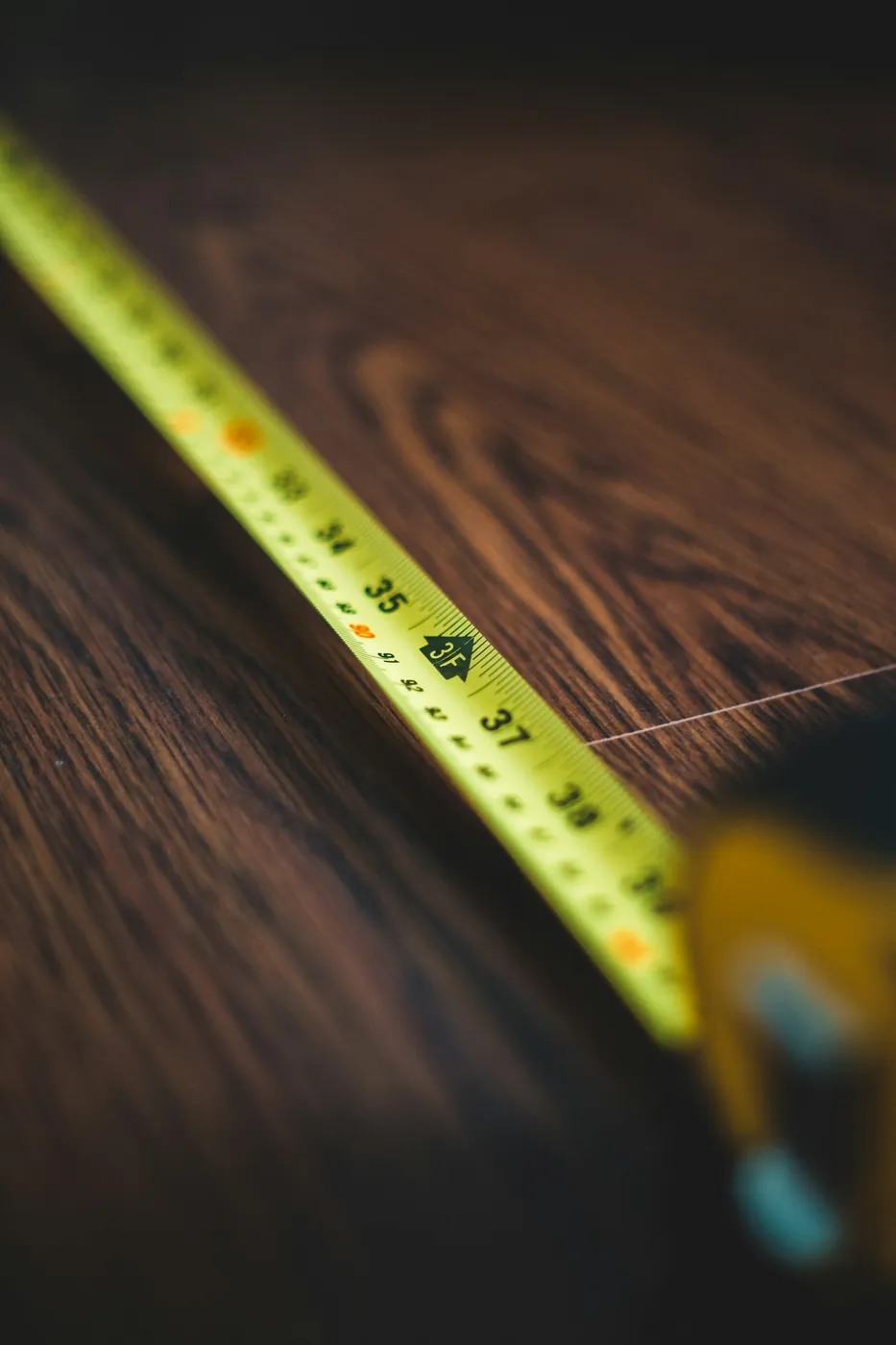 A tape measure on a wooden floor