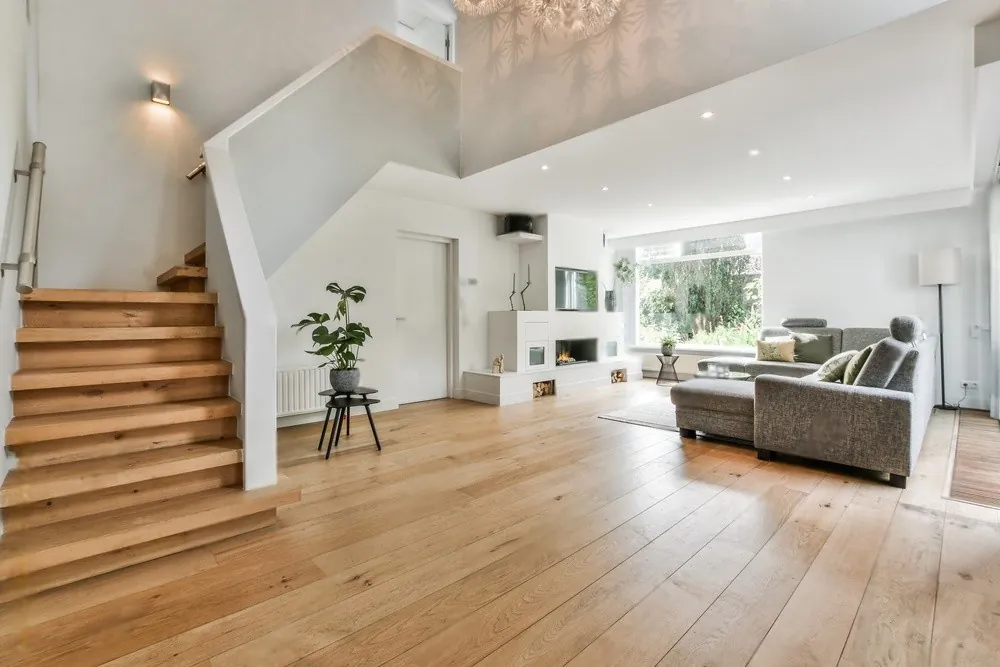 A living room with a wooden staircase