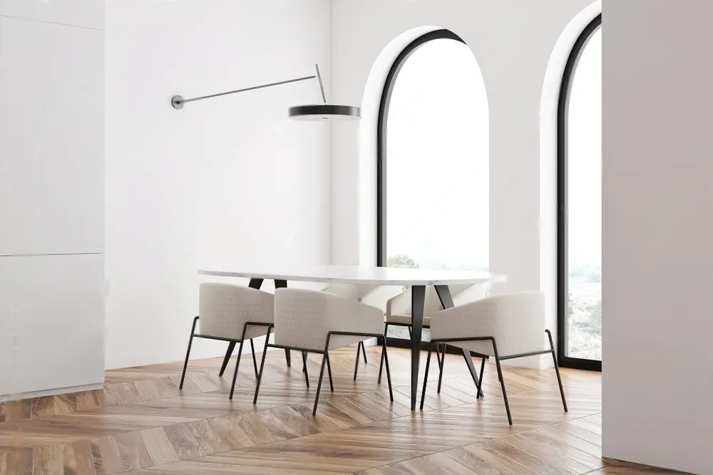 A white dining room with arched windows