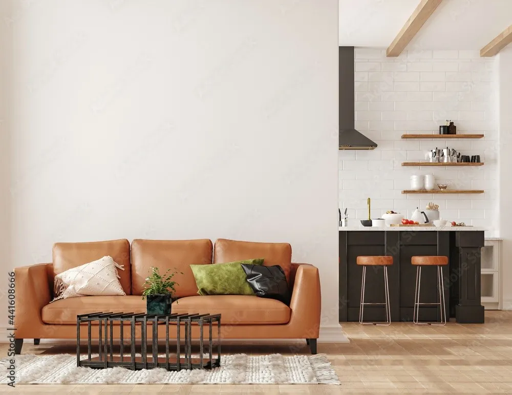 A tan leather sofa in an open kitchen