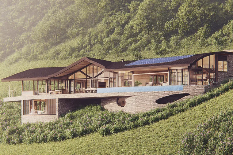 A long house with deep roofs on a green hillside