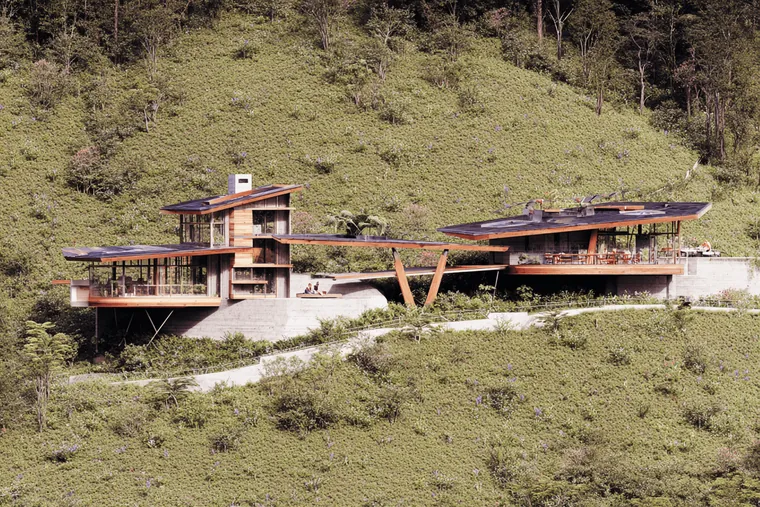 A house with terraces stepping down a grassy hill