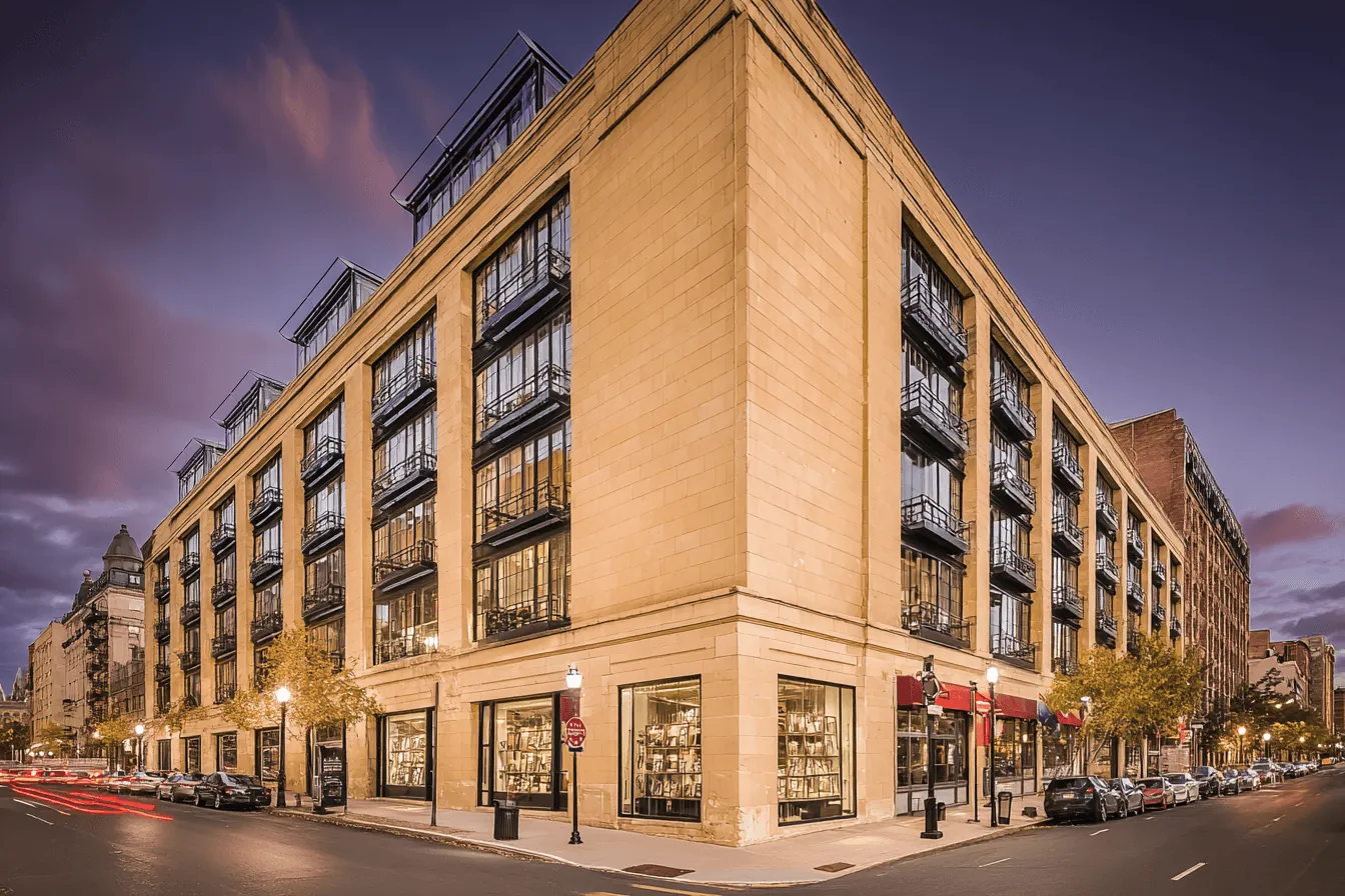 Stonebridge Lofts: a corner building of lofts with balconies at dusk