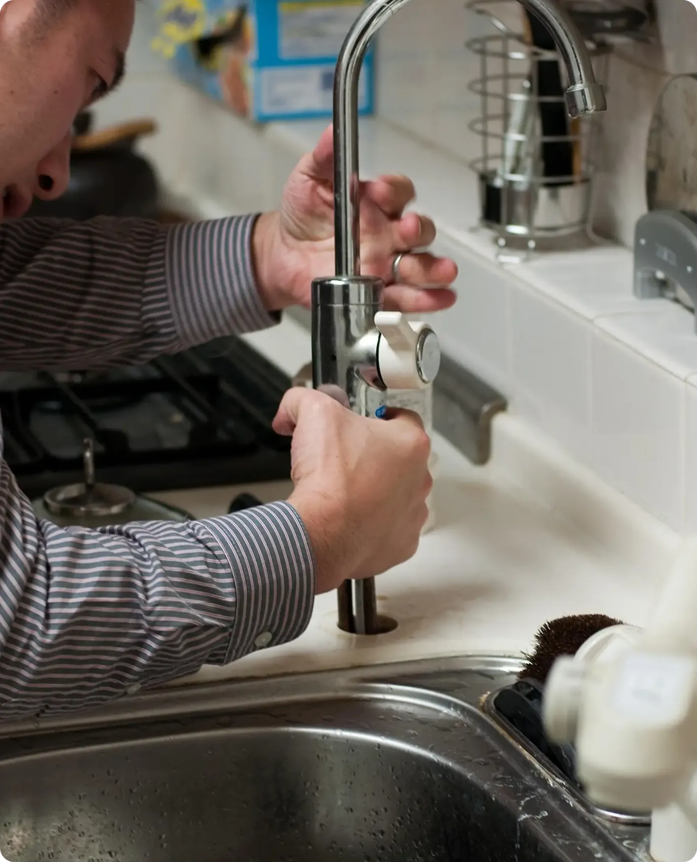 Gullwick technician repairing a kitchen tap