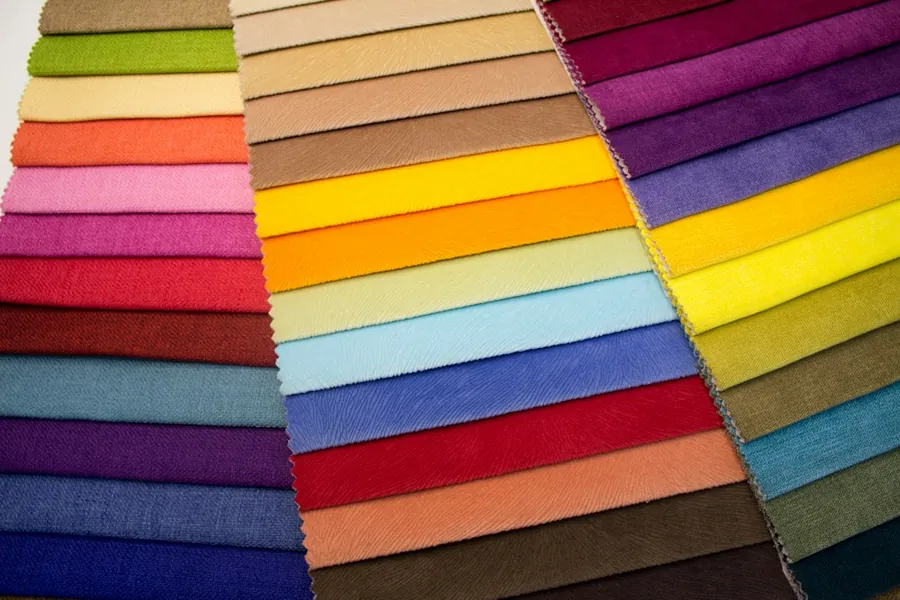 Rows of fabric samples in every colour, laid out on a table