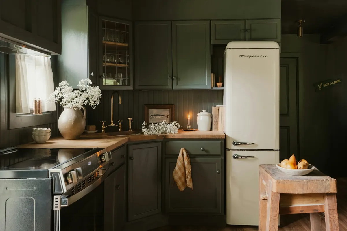 The same kitchen from further back, with a cream fridge and an oven