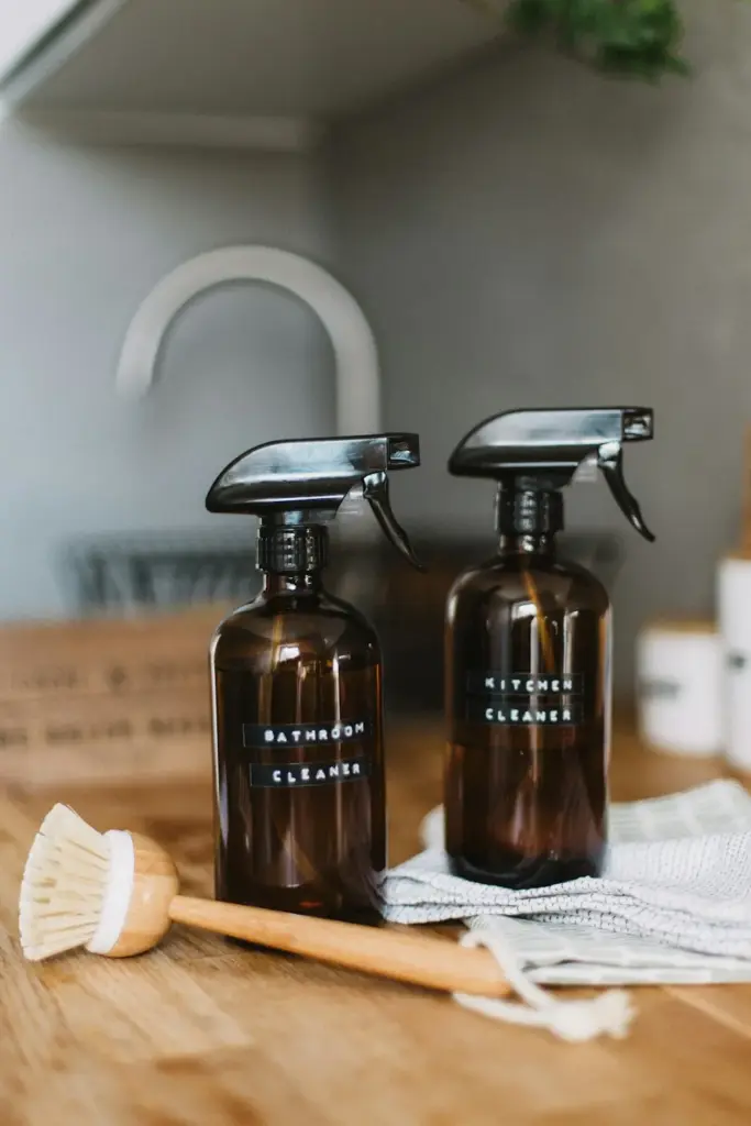 Refillable amber spray bottles and a wooden scrubbing brush