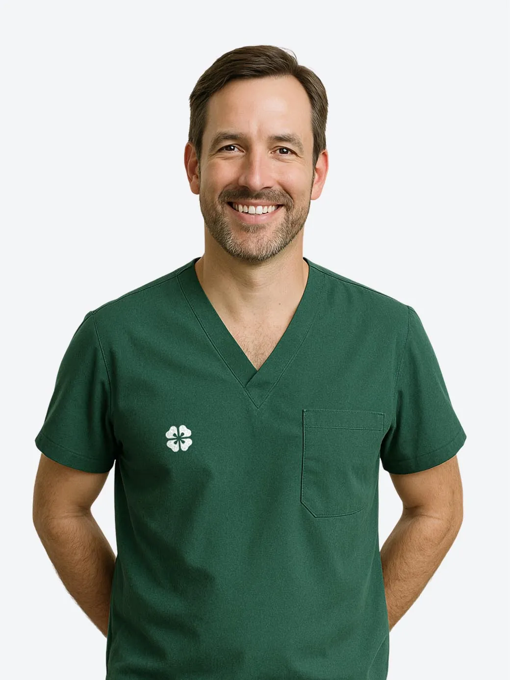 Dr. Aaron Hayes, a smiling dentist in green scrubs