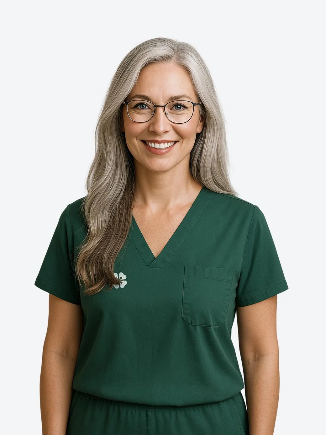 Dr. Tracy Willow, a smiling dentist with grey hair and glasses in green scrubs
