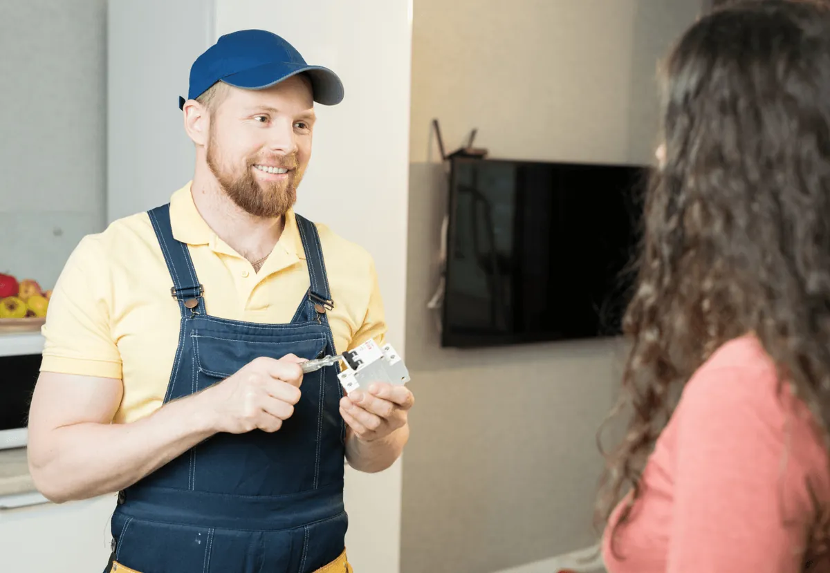A technician talking with a customer at her door