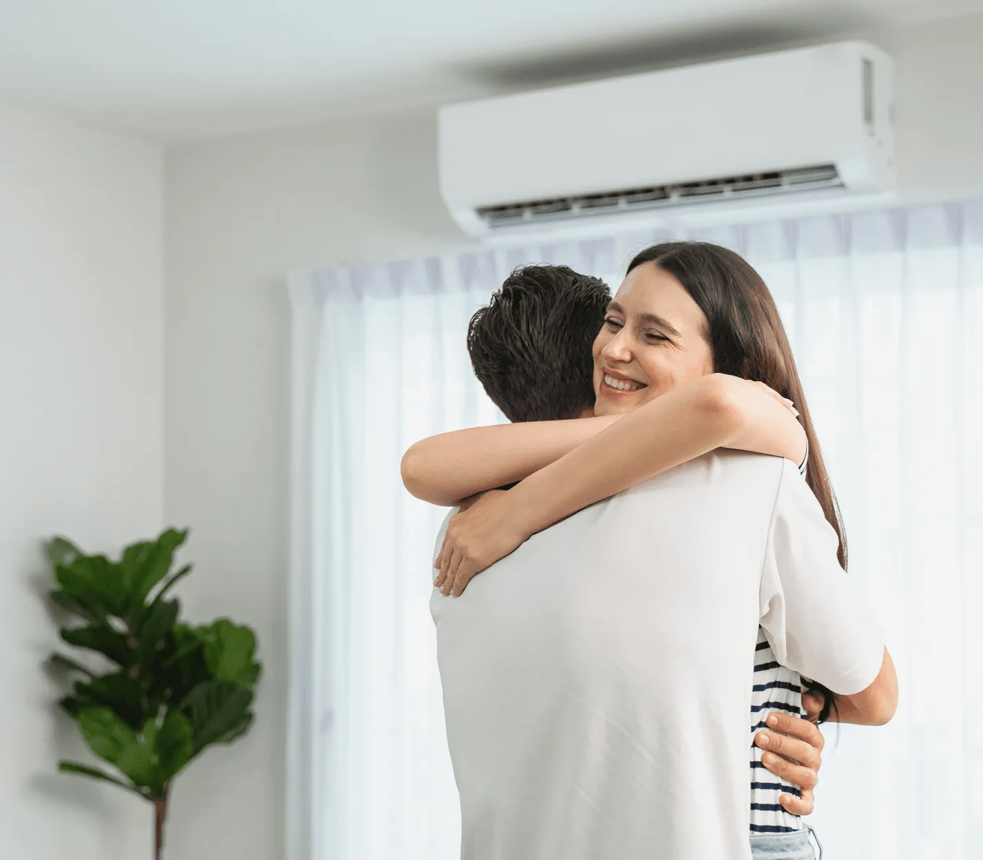 A happy couple hugging in a cool living room