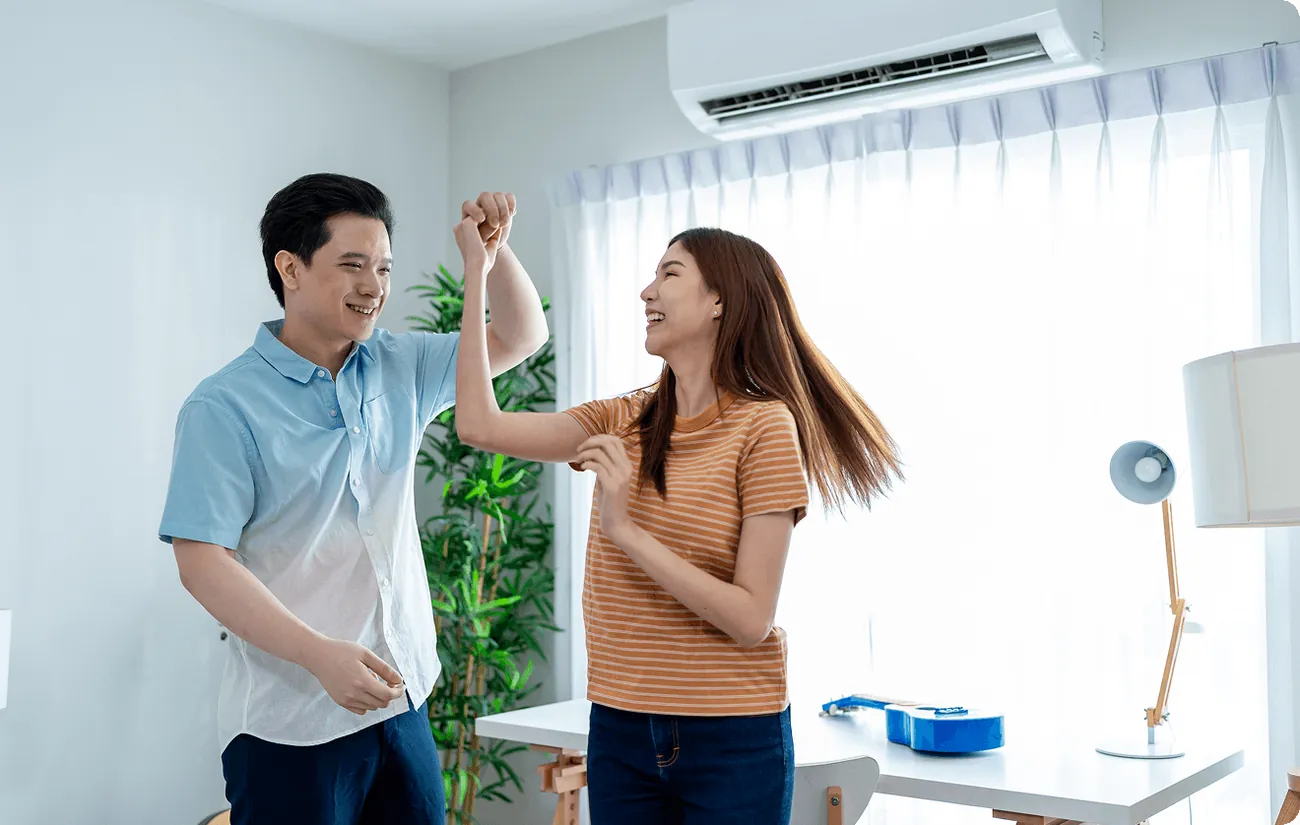 A happy couple high-fiving at home