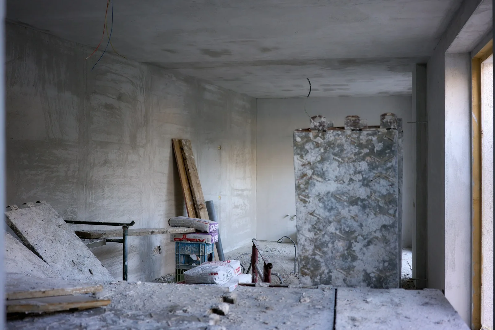 The space before the work: bare concrete and leftover timber