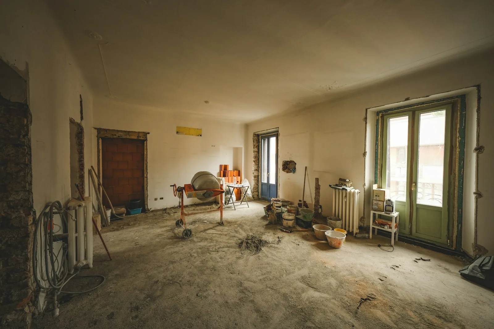 The kitchen before the work: bare walls and building debris