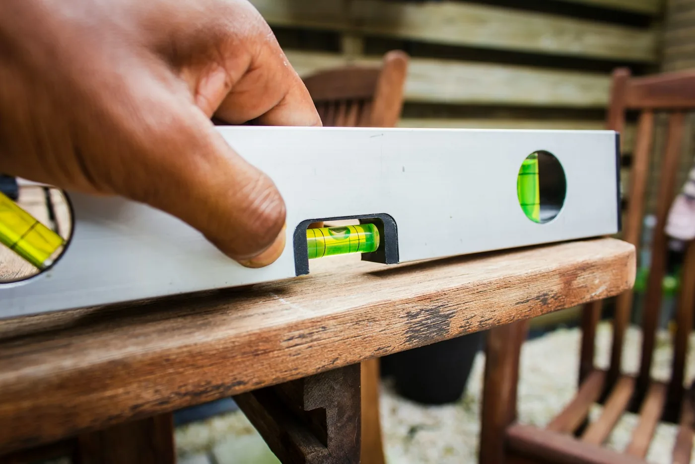 A spirit level resting on a timber surface