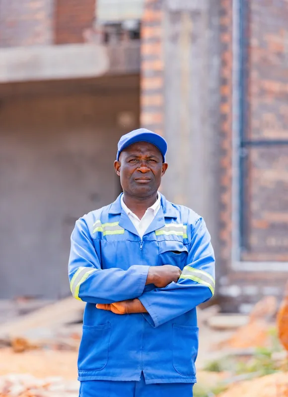 Noah Williams in blue work overalls