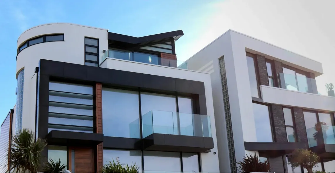 A modern white building with glass balconies
