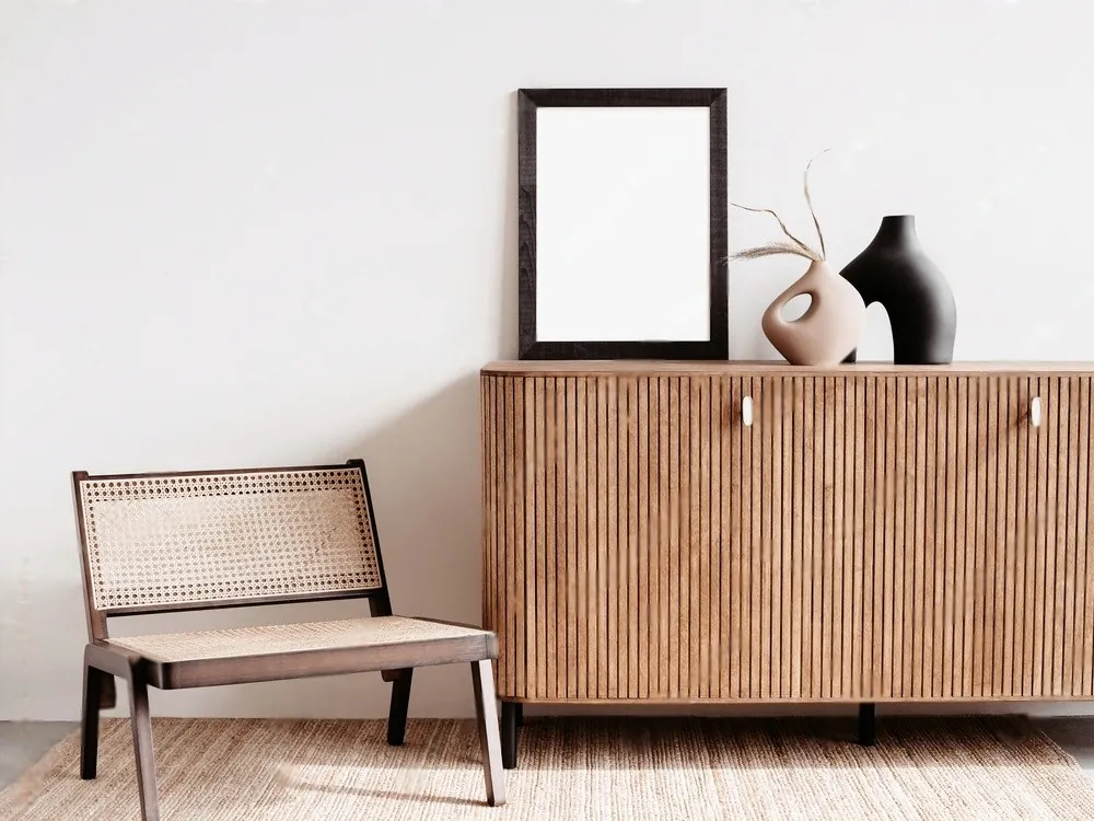 A chair and a sideboard against a white wall