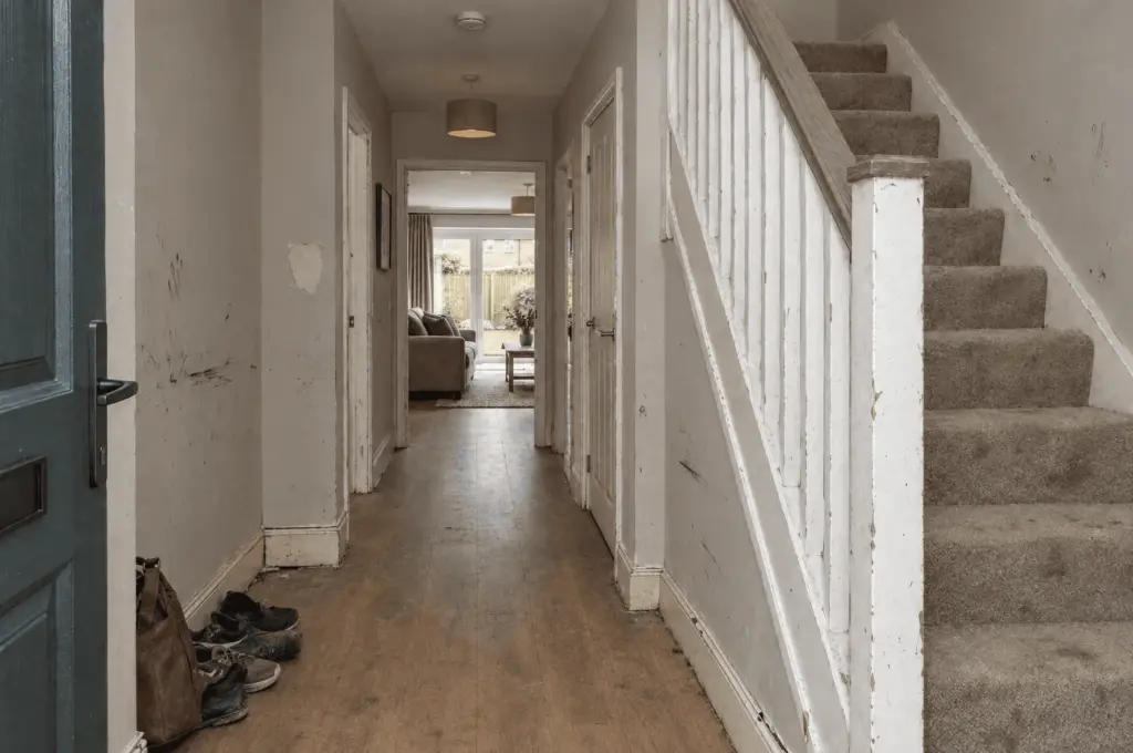 Scuffed hallway and stairs in a Westcombe new-build before decorating