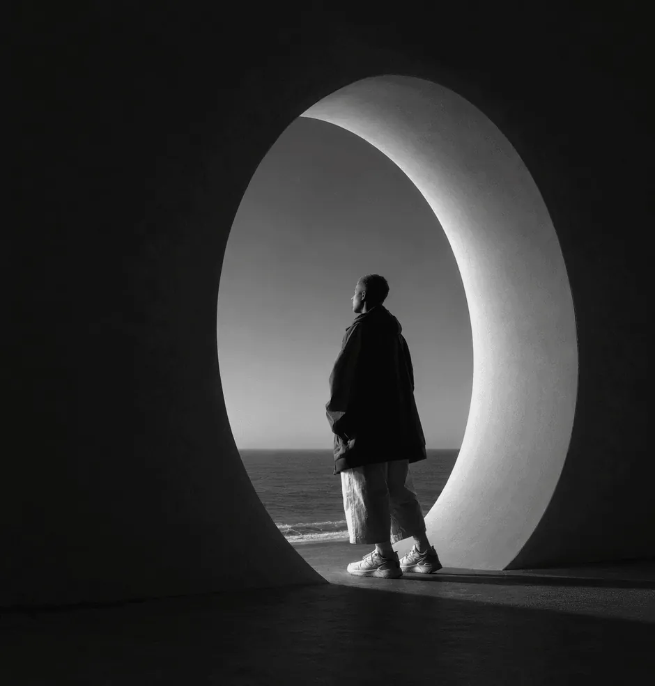 A figure at a glowing circular opening