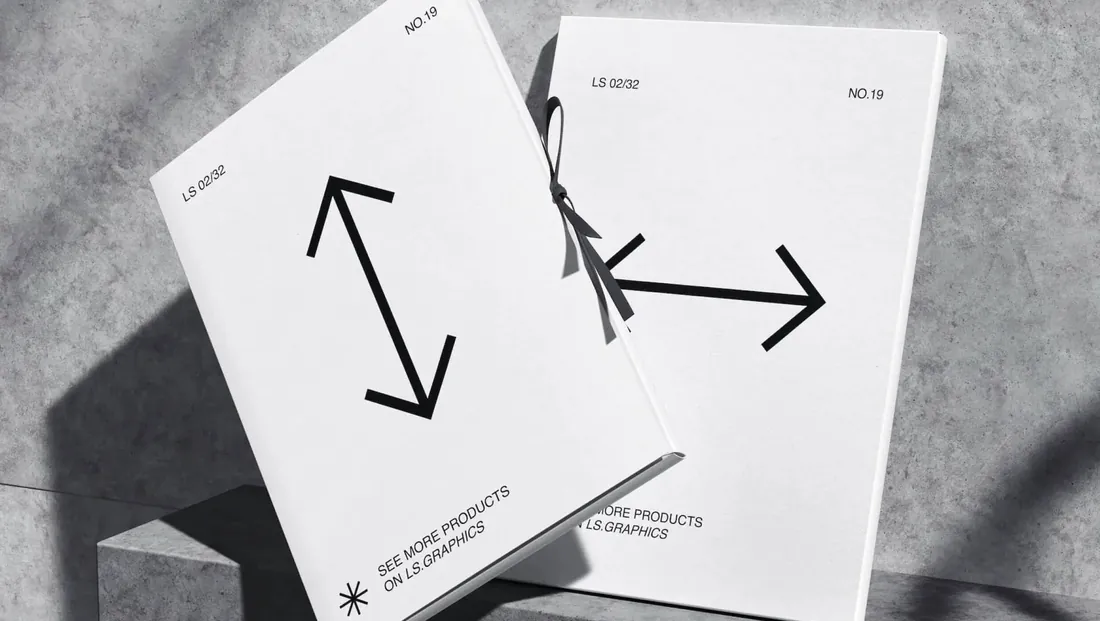 Two letterheads with arrow marks on a grey surface
