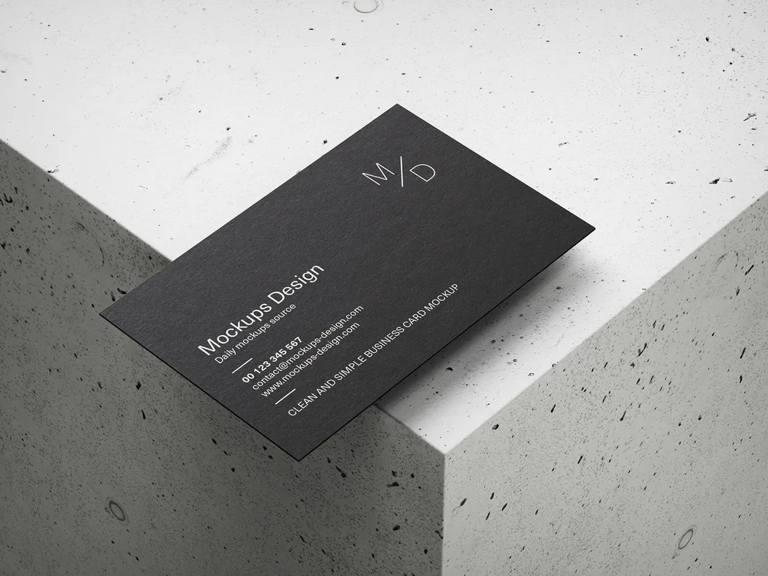 A black business card on the corner of a concrete block