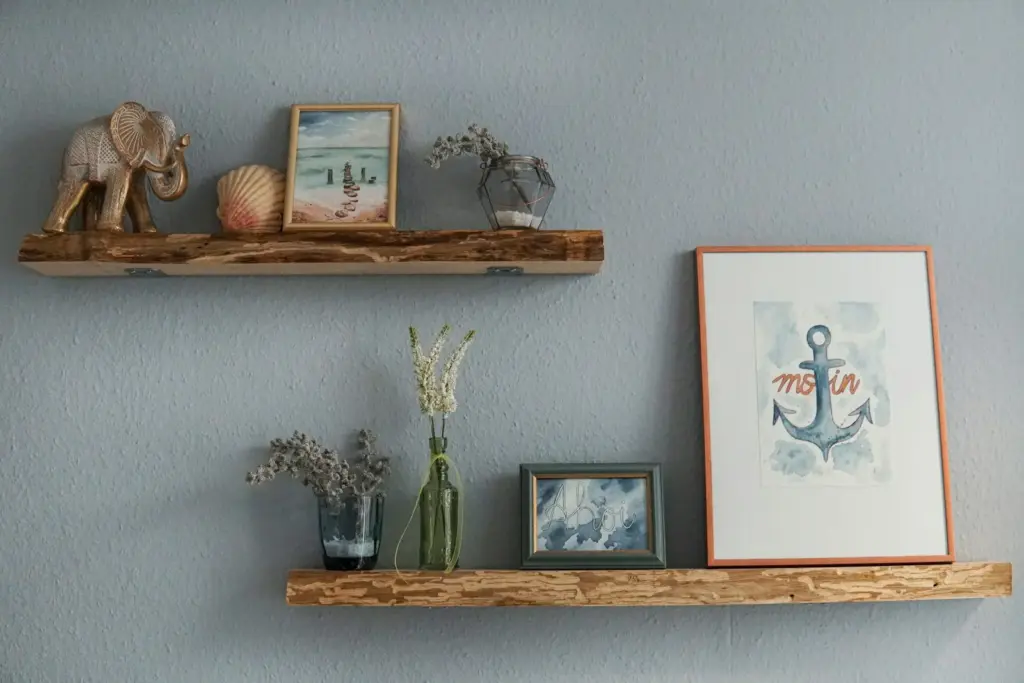 Floating wooden shelves with framed prints