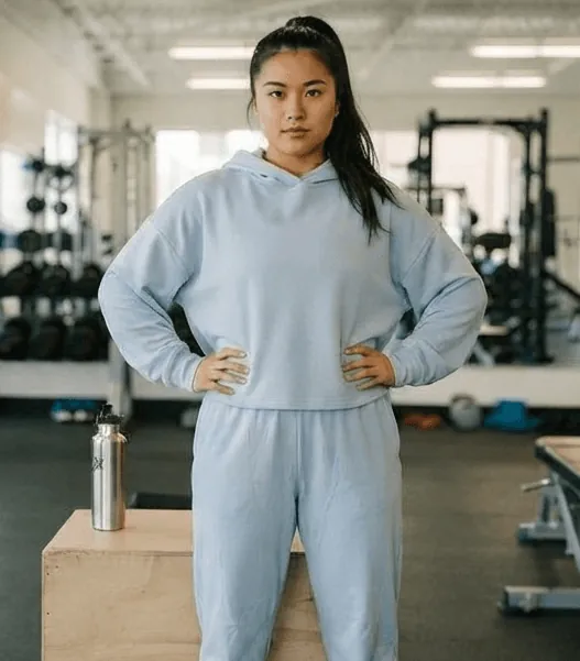Before: a woman in a grey hoodie in the gym
