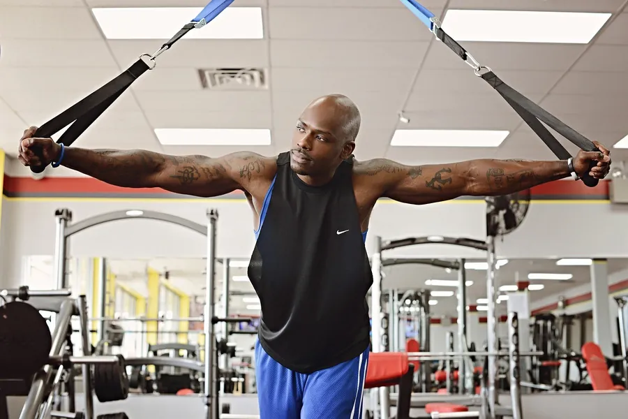 A man training with suspension straps in a gym