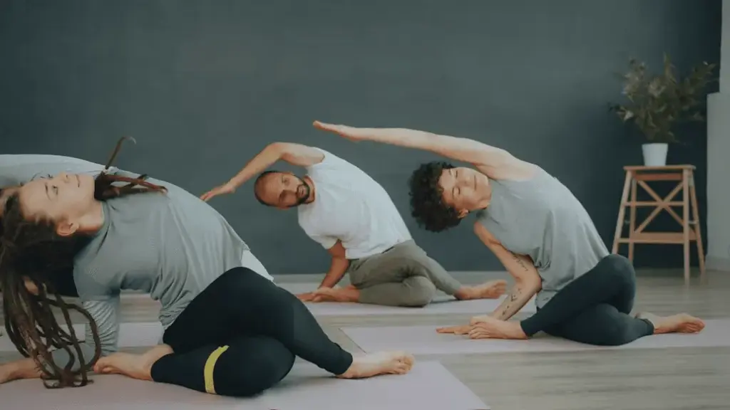 A small group doing a seated side stretch