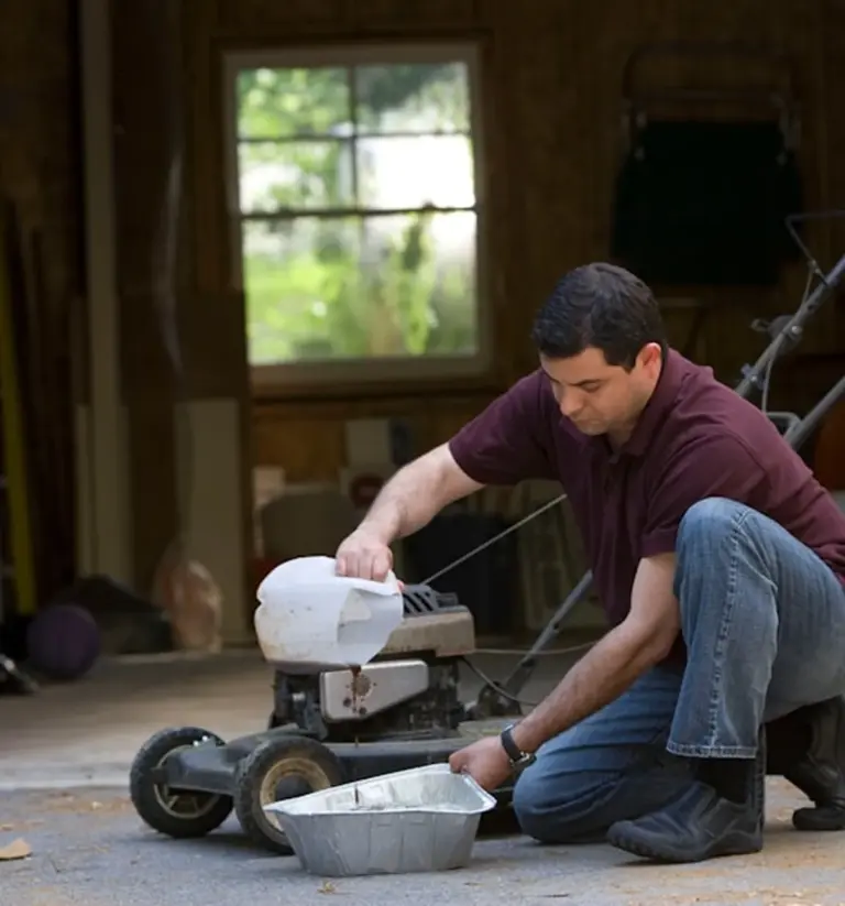 A man servicing equipment in a garage